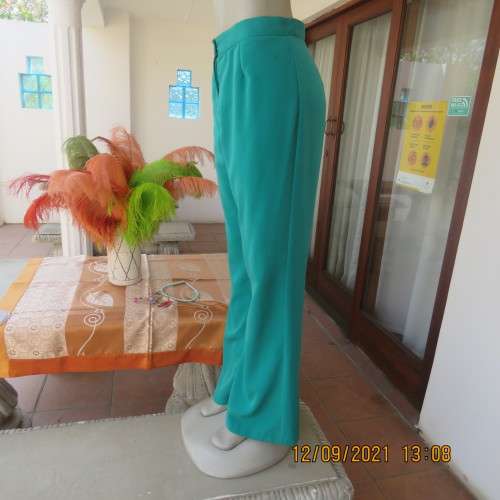 Fabulous 100% polyester teal colour dress pants in size 38/14. Bootlegged, no pockets. New condition