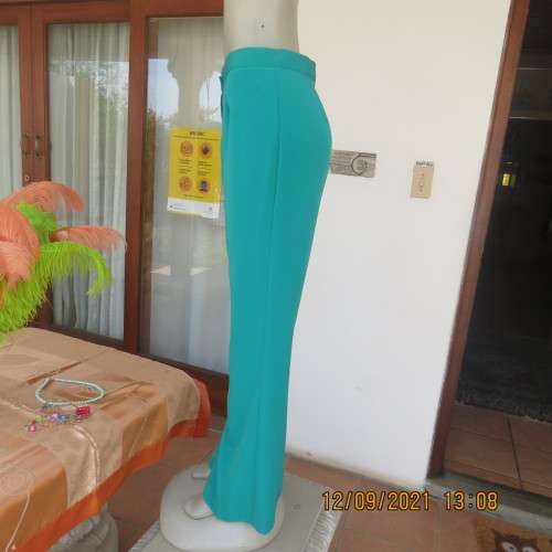 Fabulous 100% polyester teal colour dress pants in size 38/14. Bootlegged, no pockets. New condition