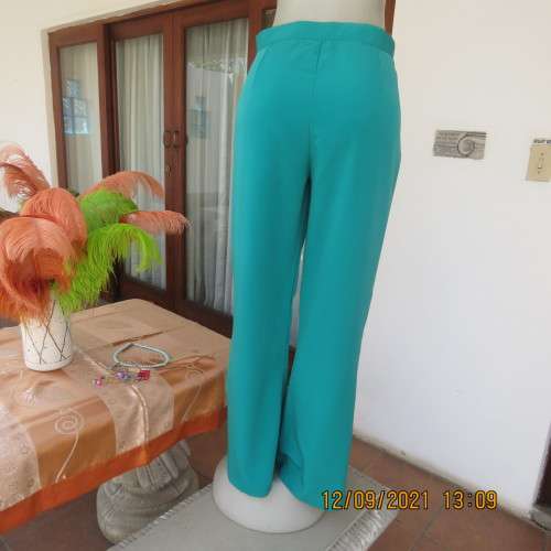 Fabulous 100% polyester teal colour dress pants in size 38/14. Bootlegged, no pockets. New condition