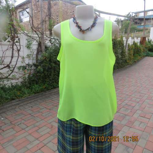 Sheer neon yellowgreen loose hanging sleeveless top. Slip over with scooped neckline. Size 38/14.