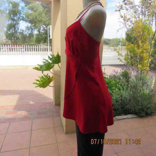 As new race red embellished evening top. Crossover bust and front. Size 38/14.Satin polyester.