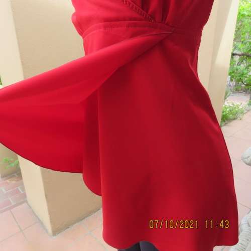 As new race red embellished evening top. Crossover bust and front. Size 38/14.Satin polyester.