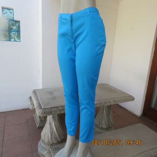 Skinny legged cerulean blue pants with side pockets and dummies at back.Stretch cotton. Size 36/12