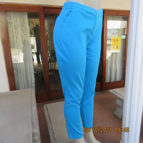 Skinny legged cerulean blue pants with side pockets and dummies at back.Stretch cotton. Size 36/12