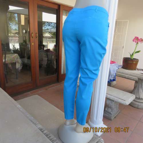 Skinny legged cerulean blue pants with side pockets and dummies at back.Stretch cotton. Size 36/12