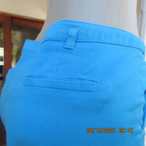 Skinny legged cerulean blue pants with side pockets and dummies at back.Stretch cotton. Size 36/12