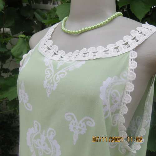 Cool mint green slip over sleeveless top richly decorated with cotton lace.Size 36/12 +.As new