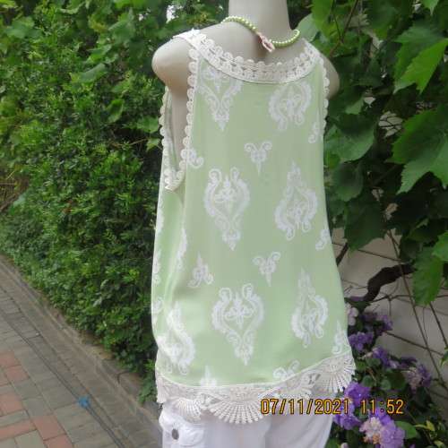 Cool mint green slip over sleeveless top richly decorated with cotton lace.Size 36/12 +.As new