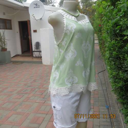 Cool mint green slip over sleeveless top richly decorated with cotton lace.Size 36/12 +.As new