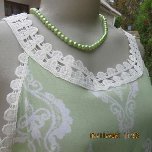 Cool mint green slip over sleeveless top richly decorated with cotton lace.Size 36/12 +.As new