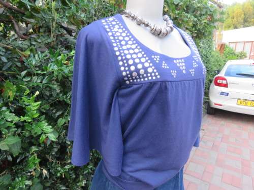 Must have navy cropped polycotton top with wide low bell sleeves. Studs on yoke front.Size 34/10.