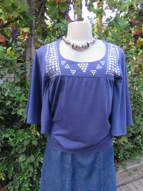Must have navy cropped polycotton top with wide low bell sleeves. Studs on yoke front.Size 34/10.