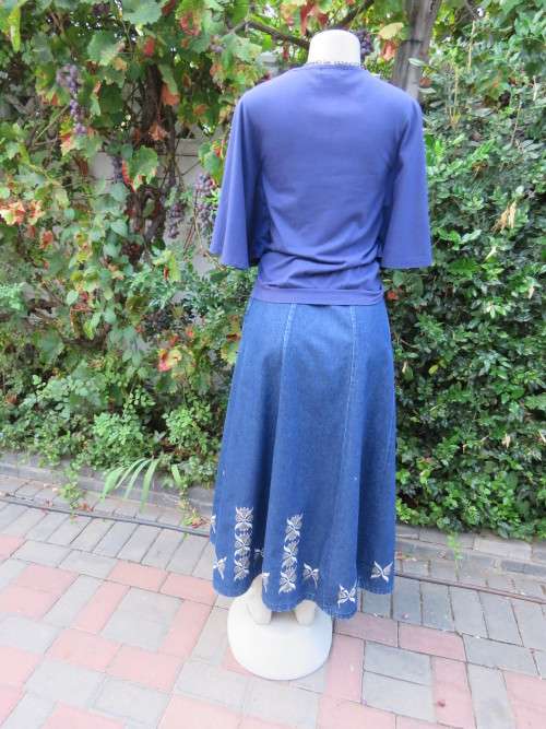 Must have navy cropped polycotton top with wide low bell sleeves. Studs on yoke front.Size 34/10.