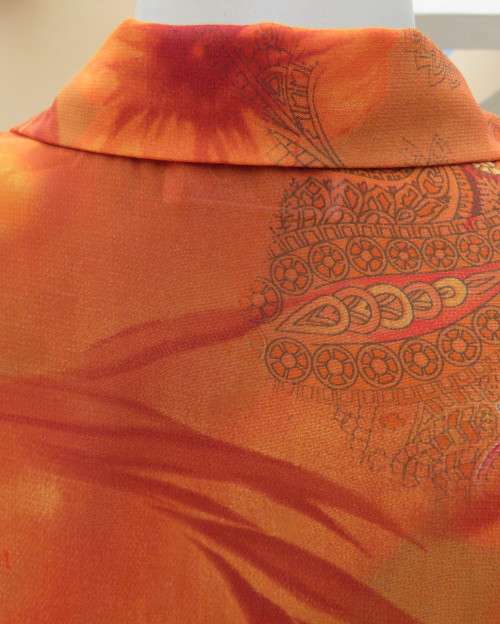 Bright orange/brick colour patterned button down top with collar by ZOEY size 36/12.Flare cuffs.
