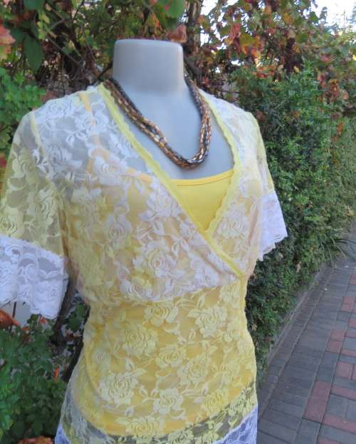 Adorable acrylic lace long empire cross over top in yellow and cream with strappy top.Size 38/14.