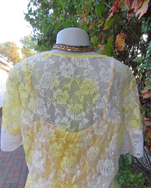 Adorable acrylic lace long empire cross over top in yellow and cream with strappy top.Size 38/14.