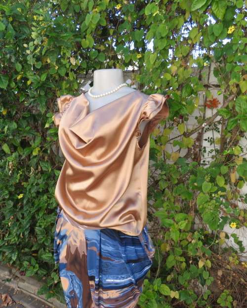 Sexy shiny gold colour blouson style top with elasticated hemline and frilled capped sleeves.Size 32