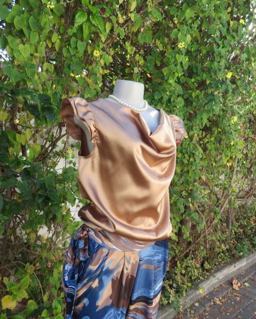 Sexy shiny gold colour blouson style top with elasticated hemline and frilled capped sleeves.Size 32