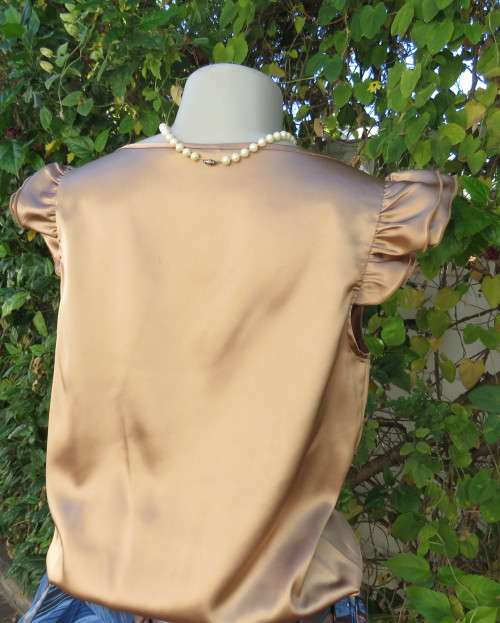 Sexy shiny gold colour blouson style top with elasticated hemline and frilled capped sleeves.Size 32