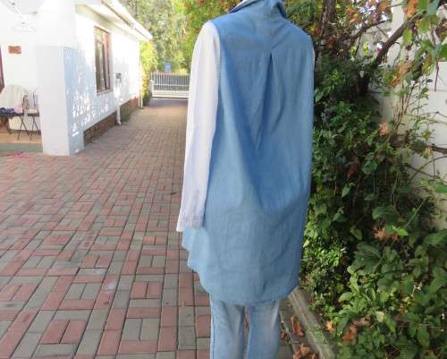 Versatile light blue denim 100% cotton long loose top with hidden button down.Size 38