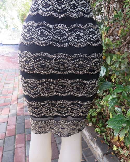Stunning sexy evening bodycon in black stretch polyester with black/gold lace.Size 32 As new.