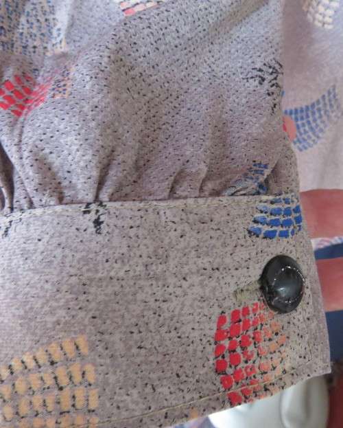 As new REFLEX USA long sleeve light brown with coral/blue pattern blouse.Silky polyester.Size 42
