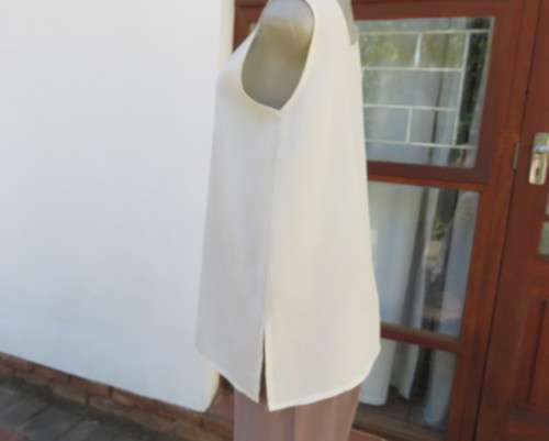 As new rich cream sleeveless cami style slip over top in creased polyester by IN CLOTHING size 36/12