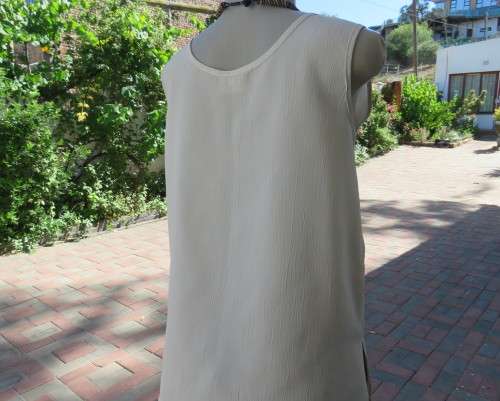 As new rich cream sleeveless cami style slip over top in creased polyester by IN CLOTHING size 36/12