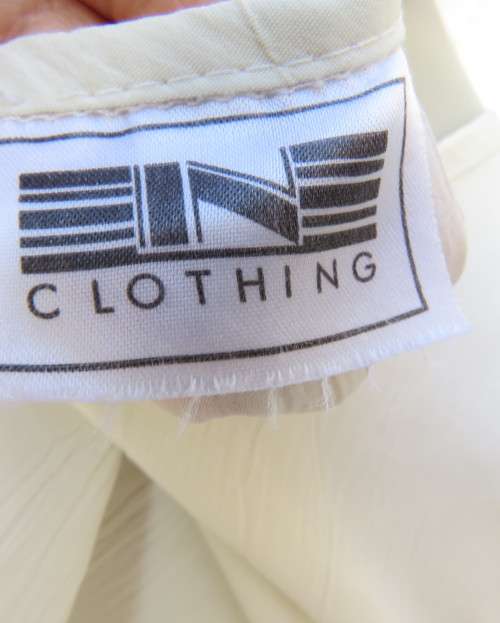 As new rich cream sleeveless cami style slip over top in creased polyester by IN CLOTHING size 36/12
