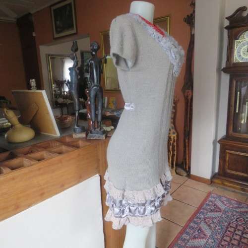 Unique ecru colour knitted dress in wool/poly and acrylic yarn.Scooped decorated neck.Size 36.As new
