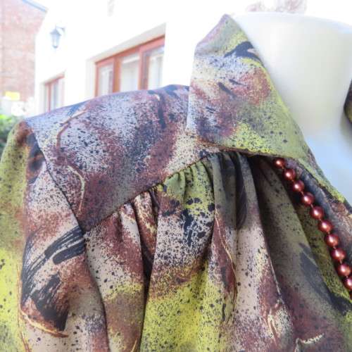 Impressive wide cut size 36/12 long sleeve top patterned in browns/greens. Gathered yokes.As new.