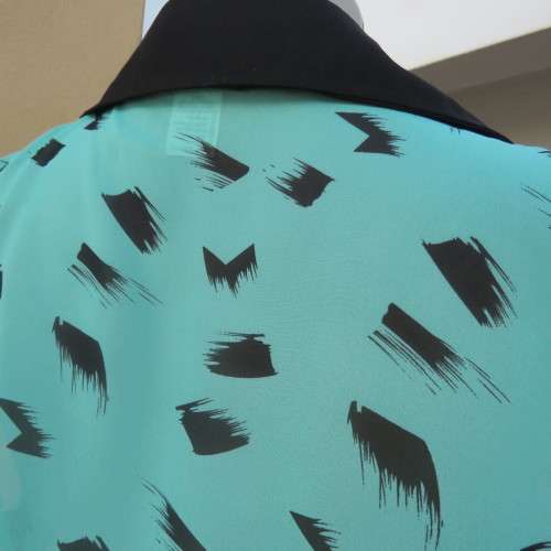 sleeveless sheer turquoise poly top with black brush marks