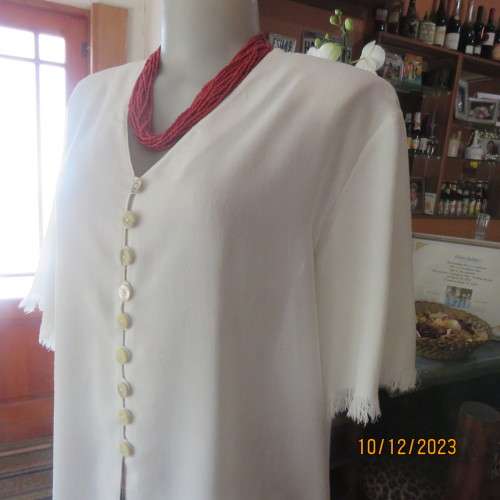 High quality light cream RAOUL size 40/16 long short sleeve top. Fringed hems. Partly button down.