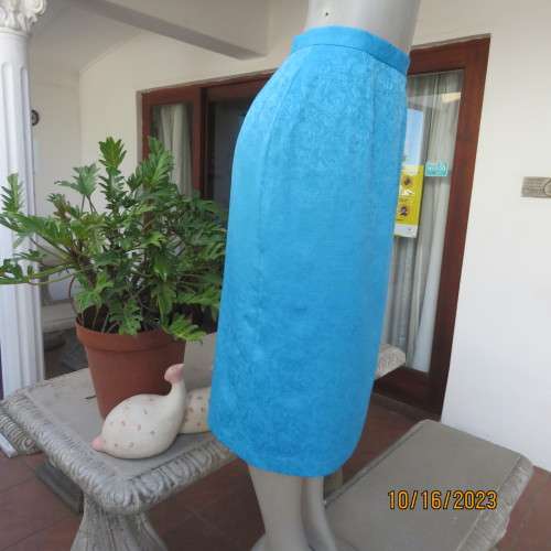 Amazing azure blue lined pencil skirt . With embossed floral pattern. Unique back pleat. Size 35/11