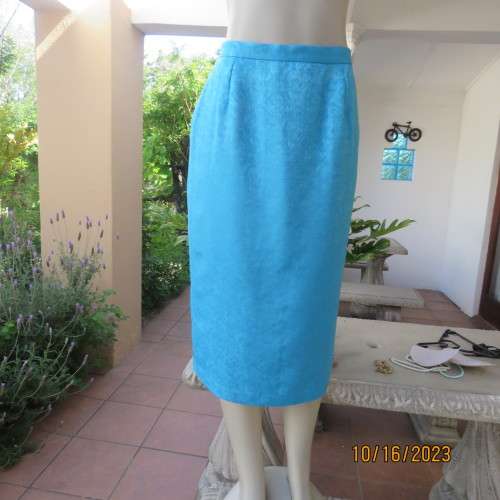 Amazing azure blue lined pencil skirt . With embossed floral pattern. Unique back pleat. Size 35/11