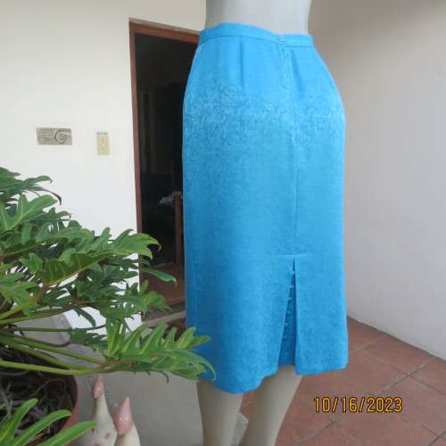 Amazing azure blue lined pencil skirt . With embossed floral pattern. Unique back pleat. Size 35/11