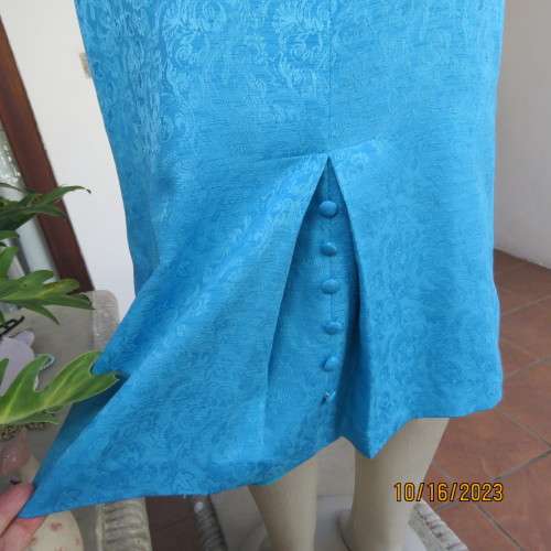 Amazing azure blue lined pencil skirt . With embossed floral pattern. Unique back pleat. Size 35/11