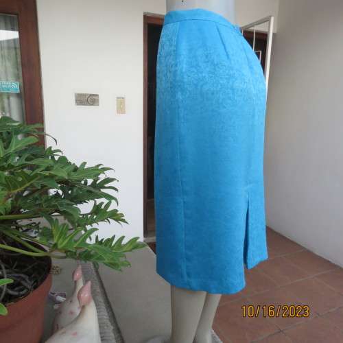 Amazing azure blue lined pencil skirt . With embossed floral pattern. Unique back pleat. Size 35/11