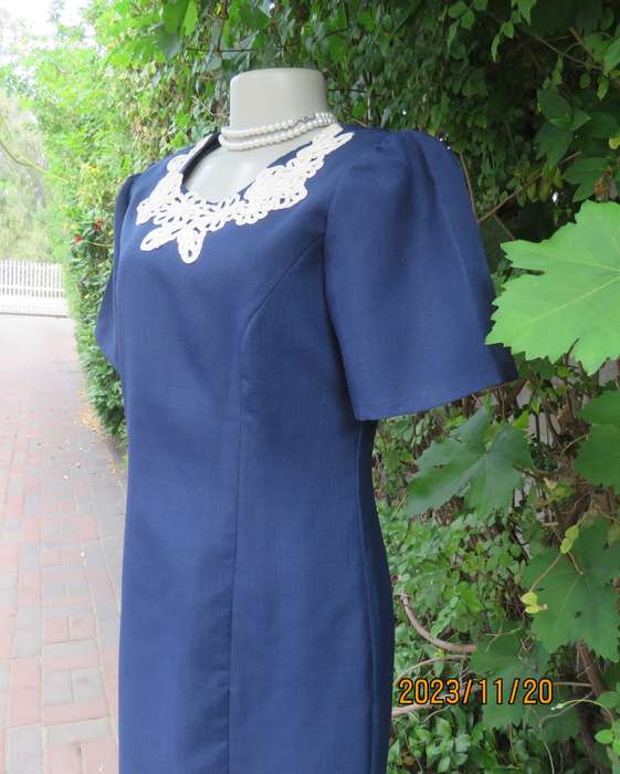 Elegant navy princess style short sleeve boutique made size 36/12 dress with U cream cord floral dec