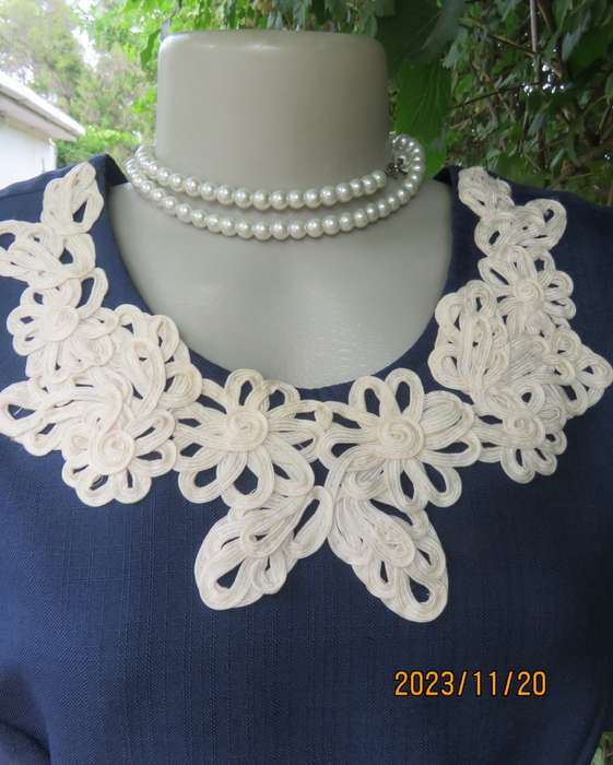 Elegant navy princess style short sleeve boutique made size 36/12 dress with U cream cord floral dec