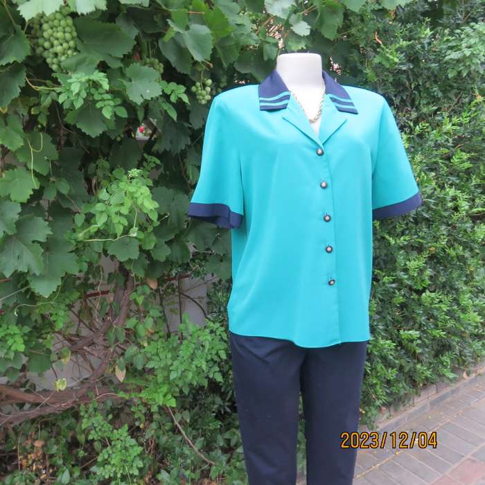 Beautiful jade silky polyester short sleeve top with navy open collar. By WOOLWORTHS size 38. As new
