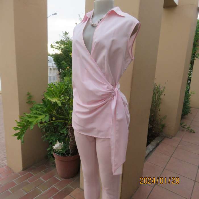 As new coral peach sleeveless cross over top with ties at side. Collar. Stretch polycotton.Size 42