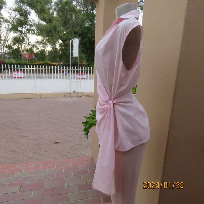 As new coral peach sleeveless cross over top with ties at side. Collar. Stretch polycotton.Size 42