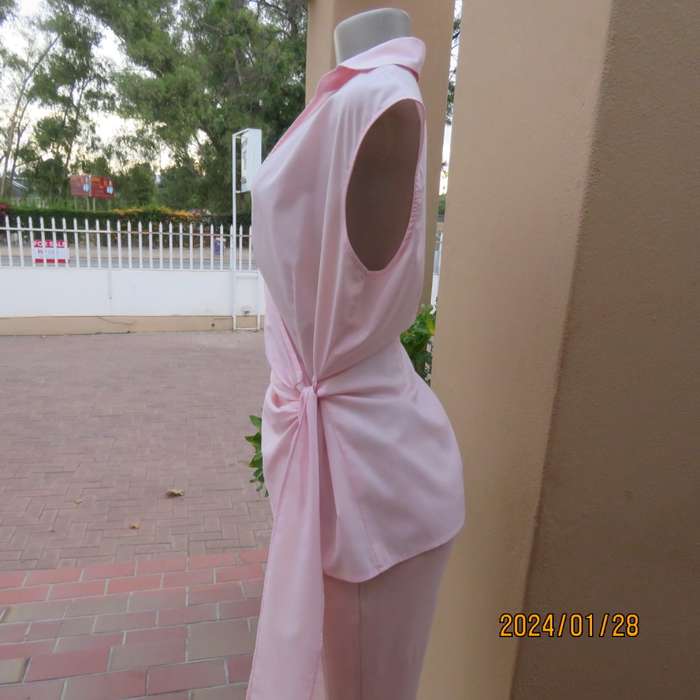 As new coral peach sleeveless cross over top with ties at side. Collar. Stretch polycotton.Size 42