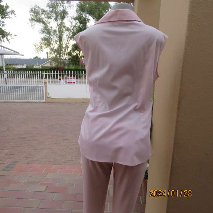 As new coral peach sleeveless cross over top with ties at side. Collar. Stretch polycotton.Size 42