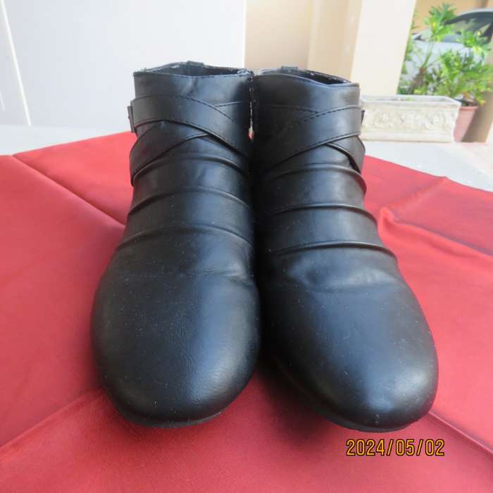 Pair of black faux leather booties in size 9 with side zips. Also an adjustable strap. Very good con