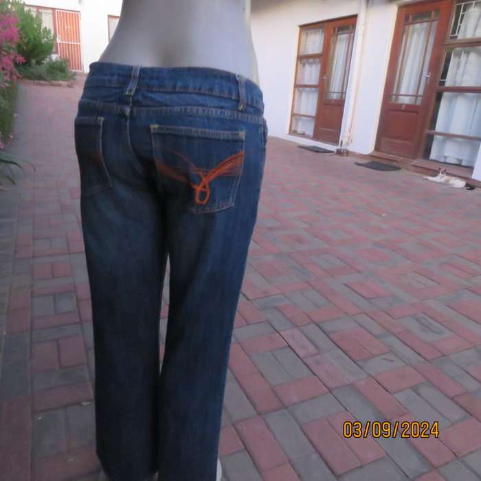 Pair of blue denim cotton Slouch fit low rise jeans by ST BERNARD size 34.Bootlegged. Very good cond