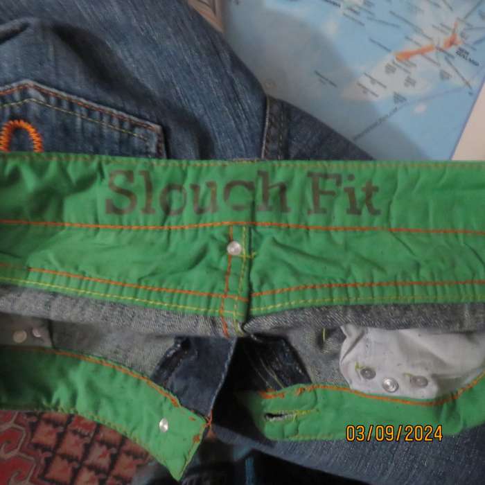Pair of blue denim cotton Slouch fit low rise jeans by ST BERNARD size 34.Bootlegged. Very good cond