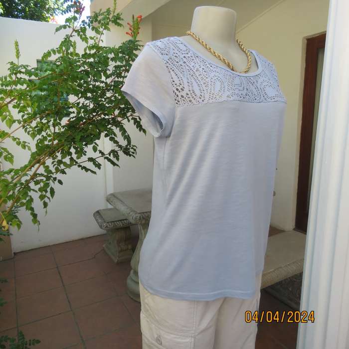 Capped sleeve light blue slip over top with polyester lace yoke. Size 36. Stretch viscose.