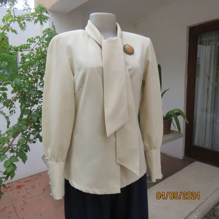 Smart rich cream 100% firm polyester long sleeve top/ Tie collar/Covered front buttons. Size 36.